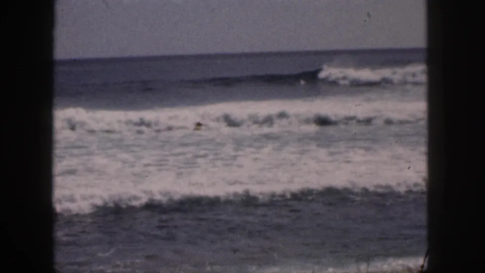 1959 Hawaii surf view with a cresting wave, white foam, and dark window-like edges around the frame.