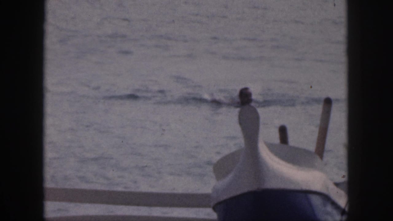 1959 Hawaii 8mm frame showing a boat bow near the ocean, partly blocked by dark frame edges.