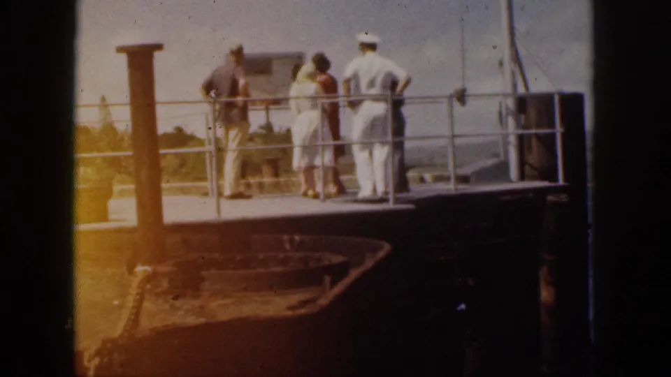 A 1959 Hawaii travel frame shows visitors at a ship dock railing with a sailor standing beside them.