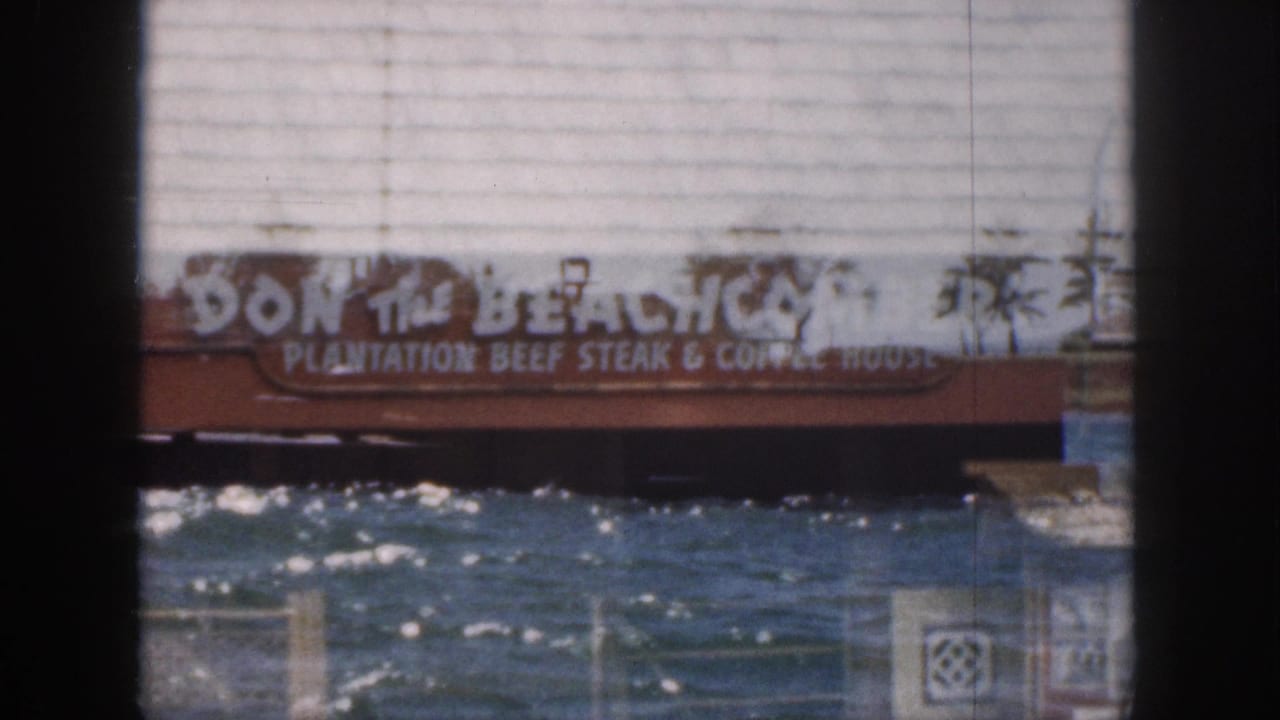 Double exposure of a Don the Beachcomber sign over shimmering water and a pier.