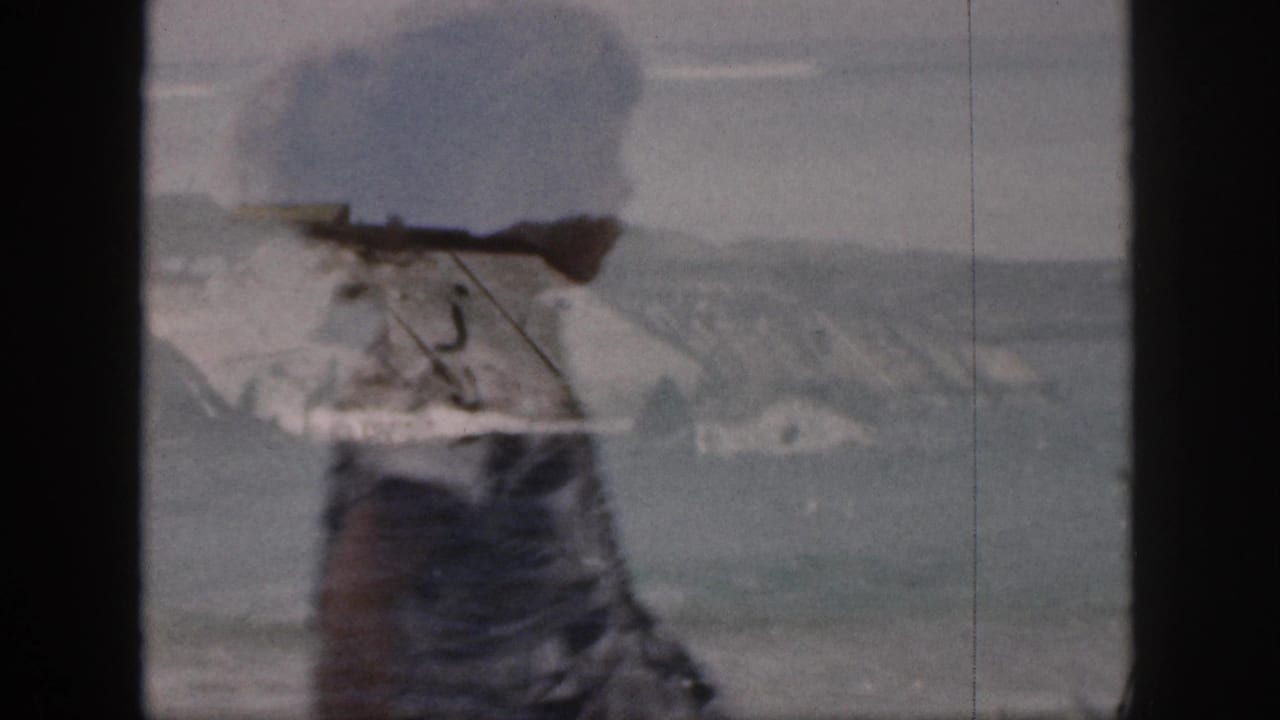 Surfers in breaking waves with a patterned-dress figure close to the camera.