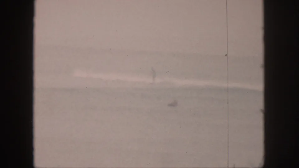 Faded 1959 Hawaii surf view with a faint wave line and a small distant sailboat-like shape near the horizon.