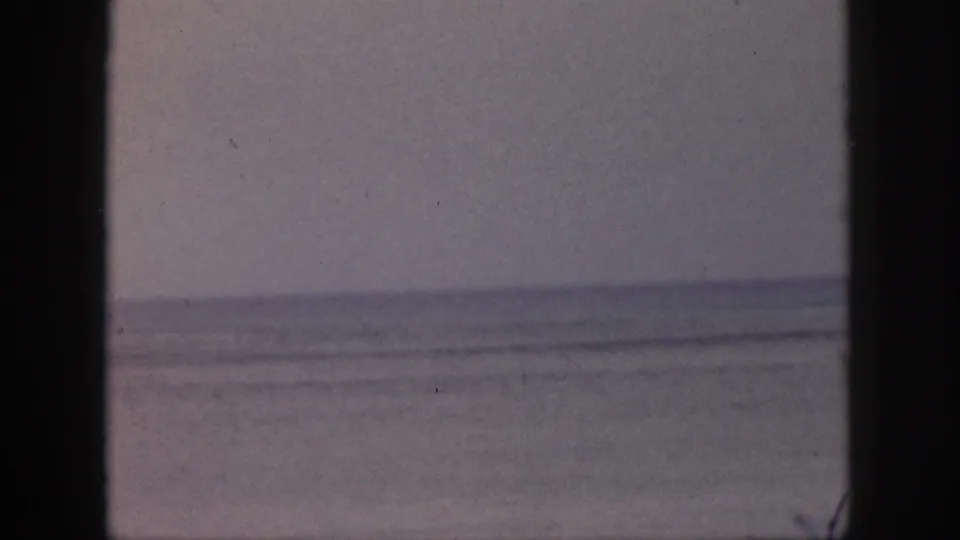 Soft 8mm Hawaii seascape from 1959, showing calm water and sky divided by dark framing at the sides.