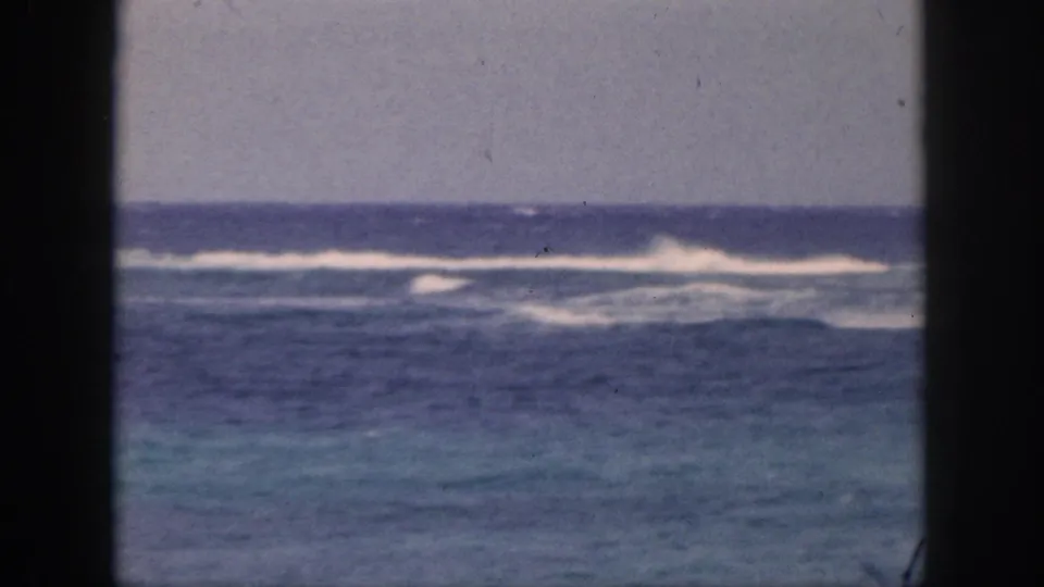 1959 Hawaii frame focused on open water, distant surf, and the horizon, with the fisherman no longer clearly visible.