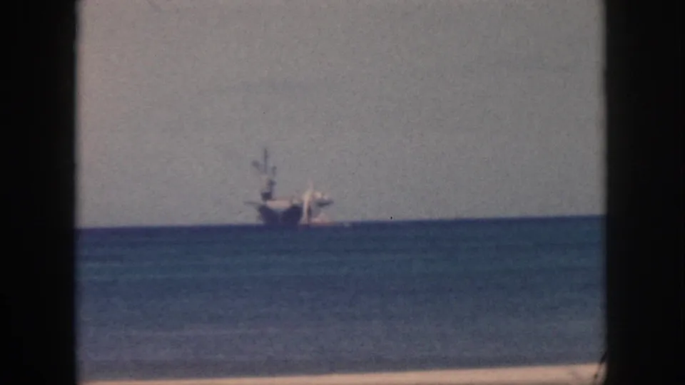 1959 Oahu 8mm frame showing the distant ship and sailboat more centered against the horizon.