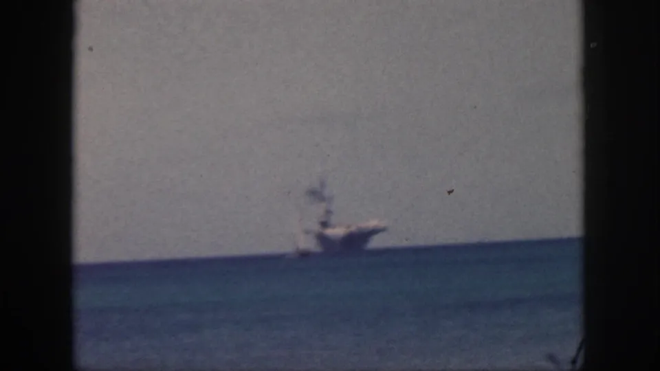 1959 Oahu 8mm frame showing a distant vessel at sea, softened by grain, haze, and slight blur.