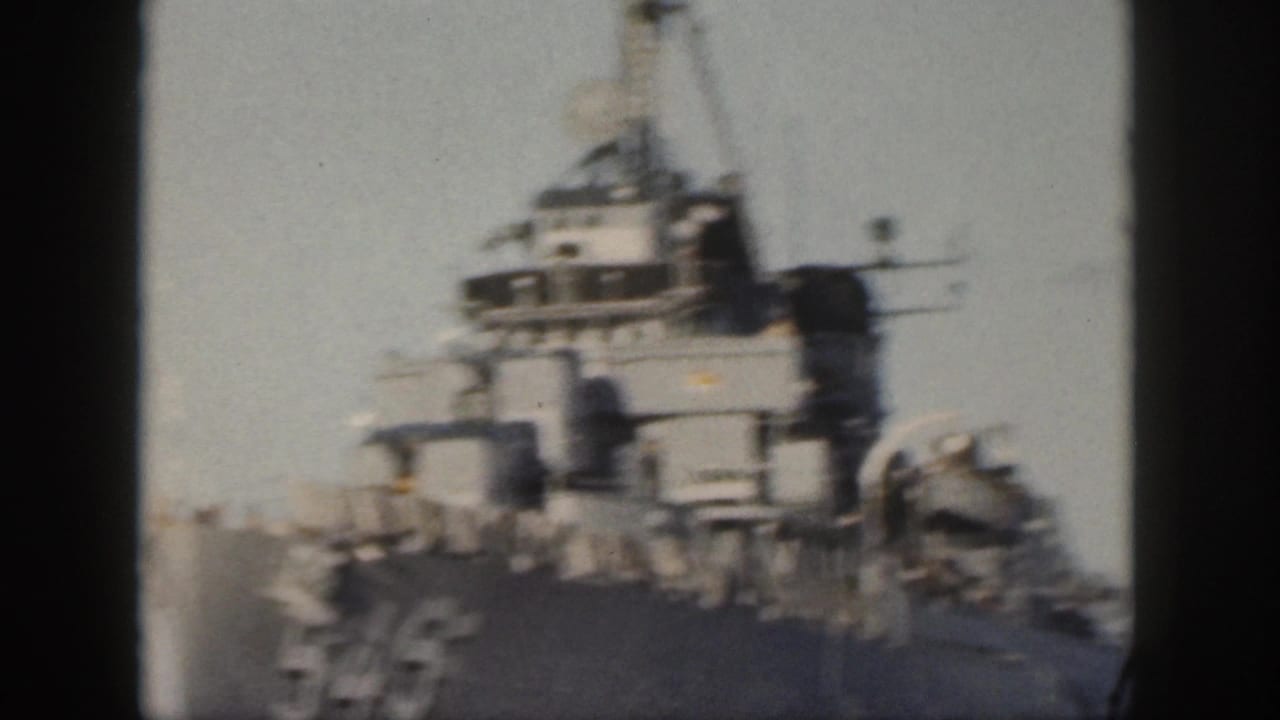 Soft 8mm frame from Oahu in 1959 showing destroyer 545 from the front-side angle, with bridge structure, mast and deck equipment visible.