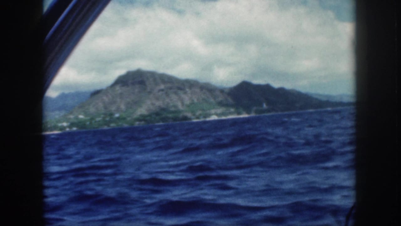1959 Oahu boat view with Diamond Head and coastline beyond dark window framing and choppy blue water.