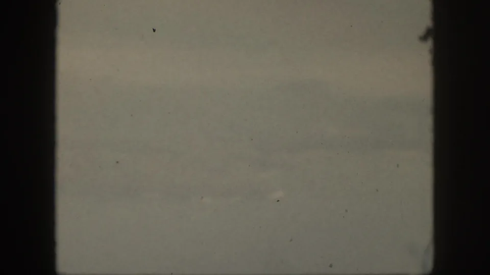 A pale, low-contrast 1959 Oahu coastal view with faint horizon bands and dark vertical gate edges.