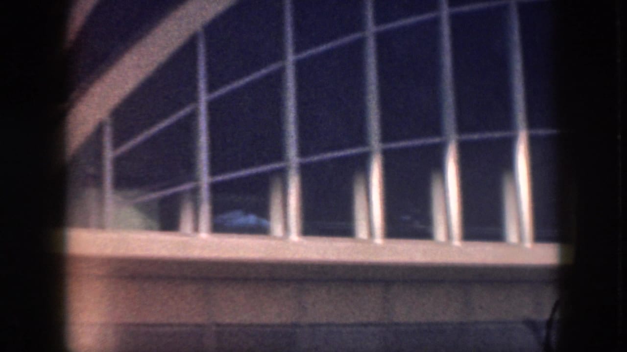 Upper window grid and curved roofline on a modern building.