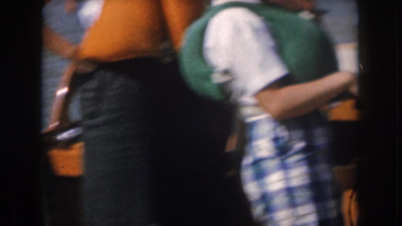 Close, blurred view of adults in life vests standing or moving on a boat.