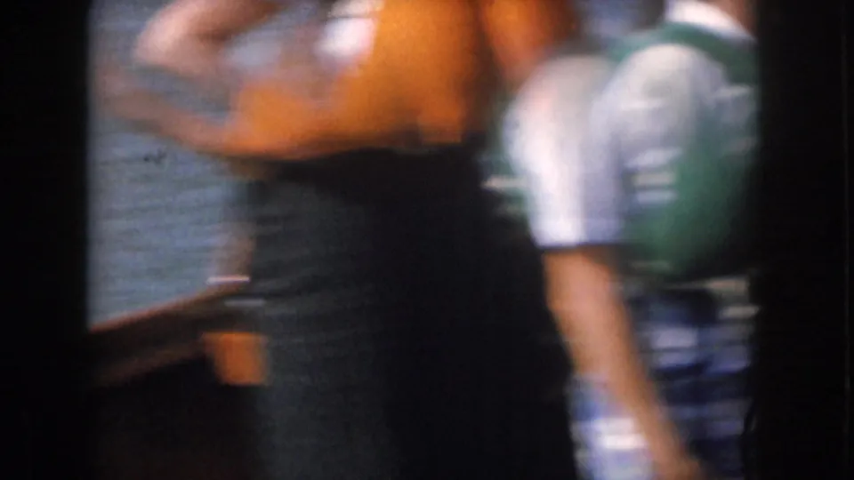 1961 Michigan boating frame with adults in orange and green life vests near the rail, softened by handheld motion blur.