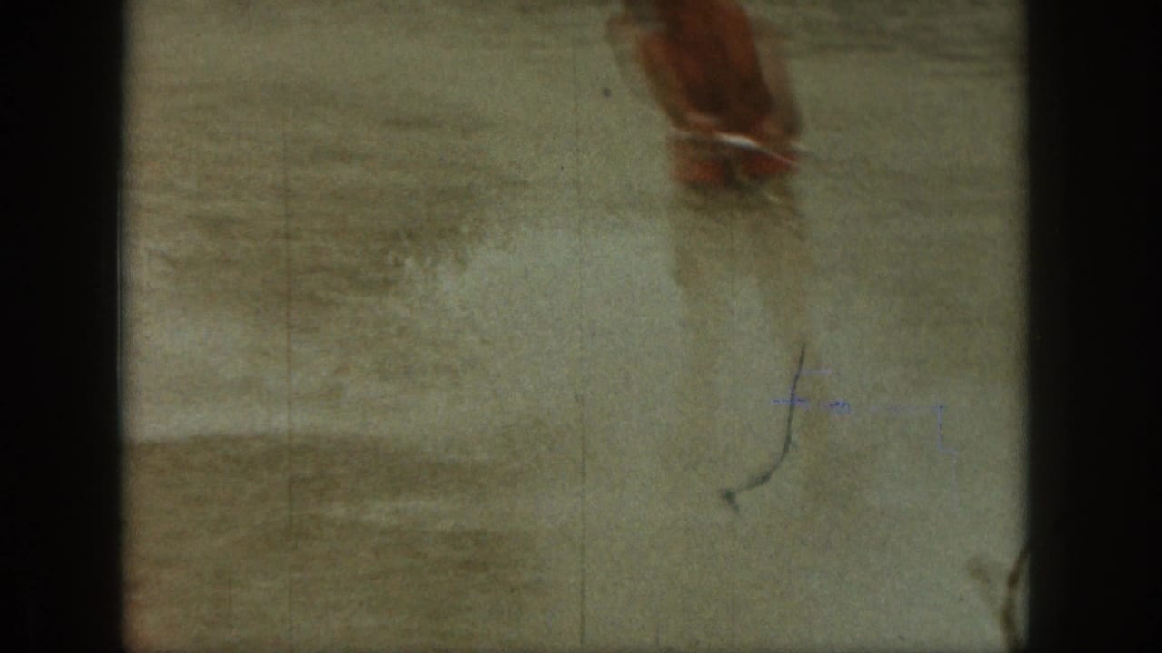 Close view of legs and water spray in shallow lake water.