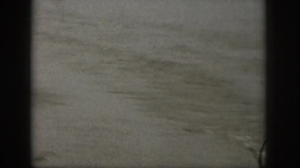 Final 1961 Michigan home-movie frame showing mostly lake water after the skier has moved out of view.