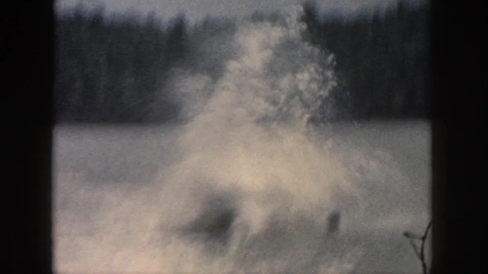 1961 Michigan 8mm frame dominated by lake spray and splash, with the skier obscured by motion and water.