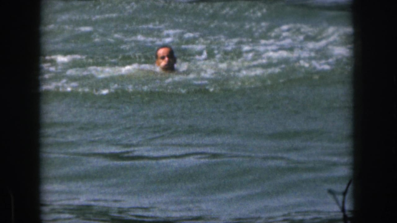 Man's head visible above choppy lake water.