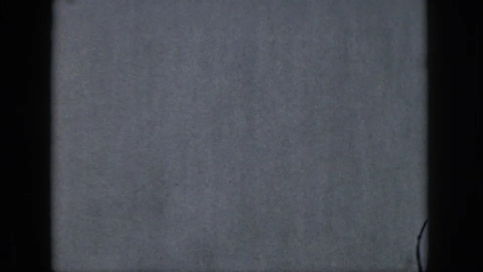 A gray-blue exposed or blank 8mm frame appears between water skiing shots, with dark film borders and visible film texture.