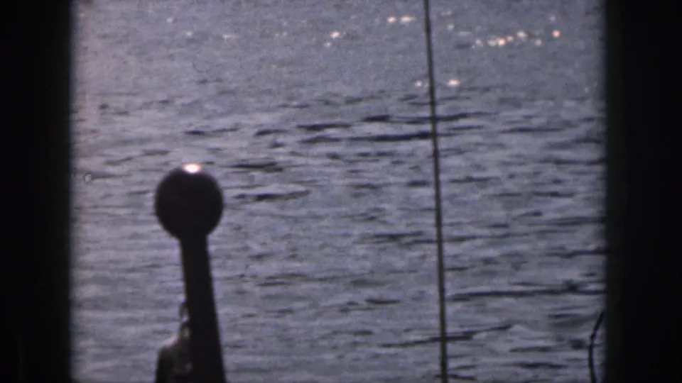 1961 Michigan frame of rippled lake water and dark 8mm frame edges, likely moments after the waterskier moved out of frame.