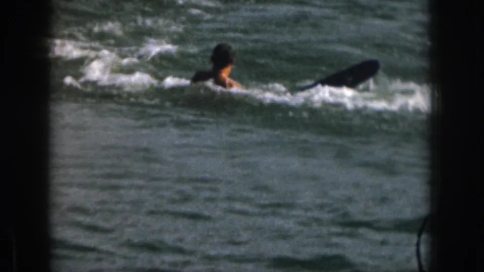At the end of the 1961 Michigan lake sequence, the skier has wiped out and is in the water while the slalom ski floats or trails nearby.