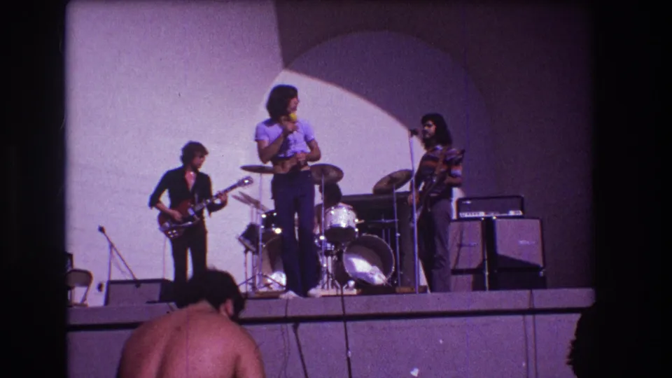 1973 Medford, New Jersey 8mm frame showing the vocalist turned toward the musicians during a small rock-band performance.