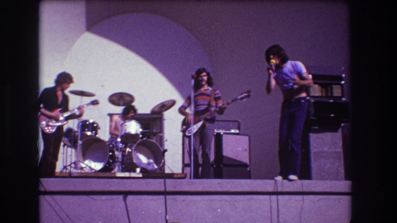 1973 Medford stage performance frame with the singer at right and three band members playing behind him.