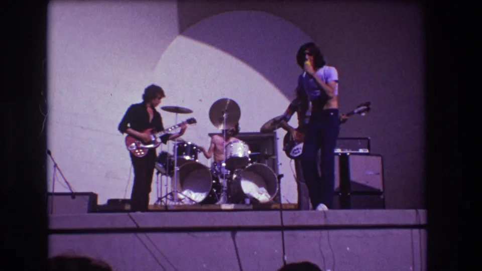 1973 Medford, New Jersey 8mm frame showing the singer near the audience side of a live rock performance.