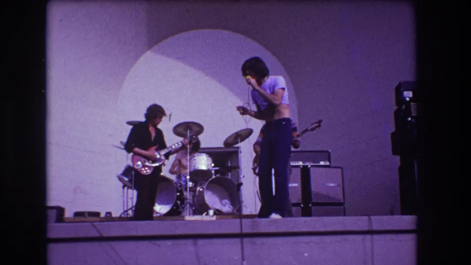 1973 Medford, New Jersey 8mm frame showing the band from a slightly different moment, with singer and guitarist foregrounded.
