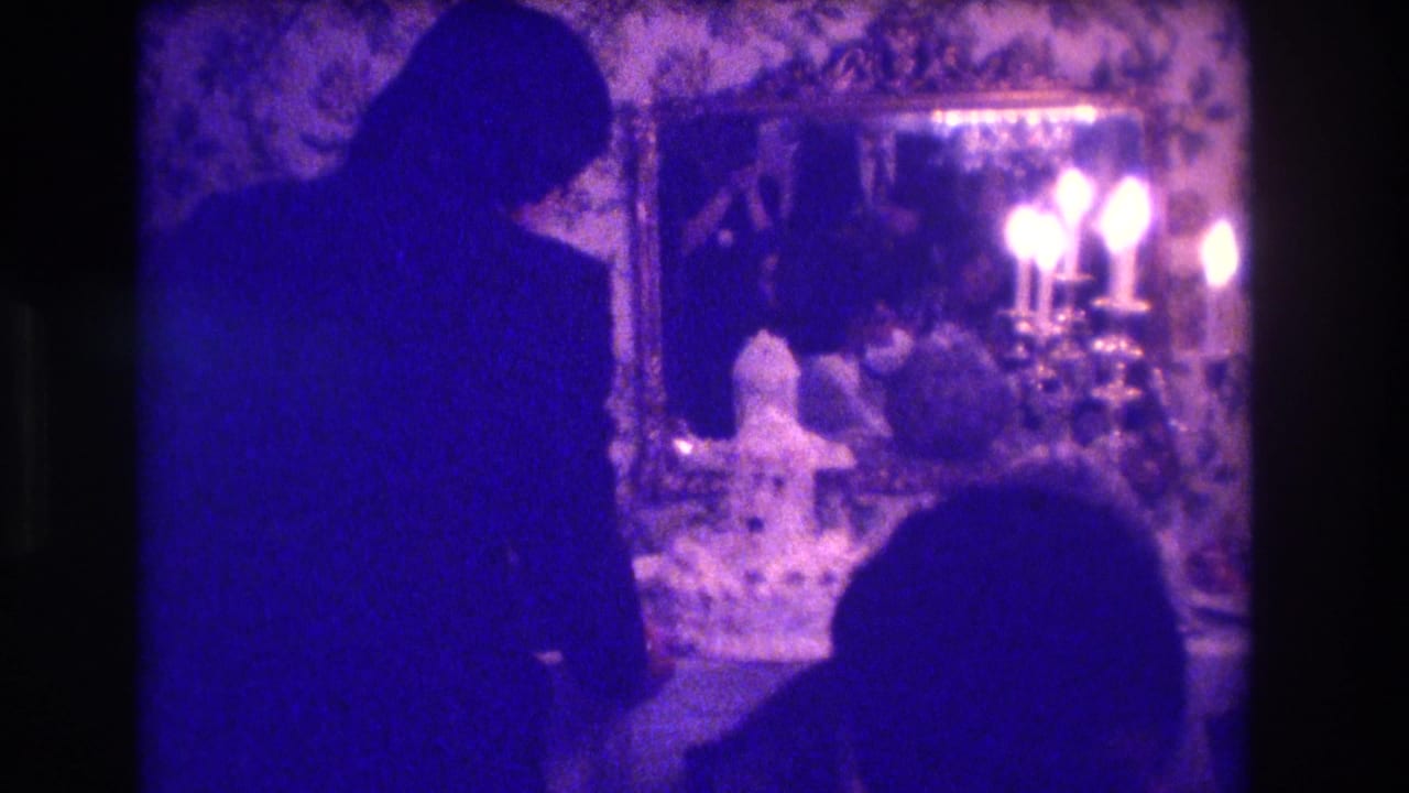 1973 Medford, New Jersey reception frame with a silhouetted wedding figure, candle flames, cake table items, and a mirror on floral wallpaper.