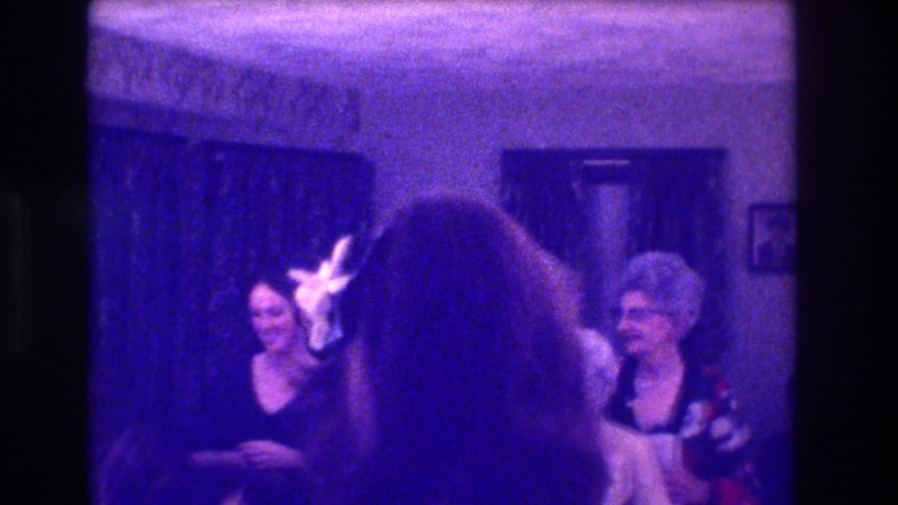 Women at a 1973 Medford, New Jersey indoor wedding reception, with one figure near the bouquet toss and guests smiling nearby.