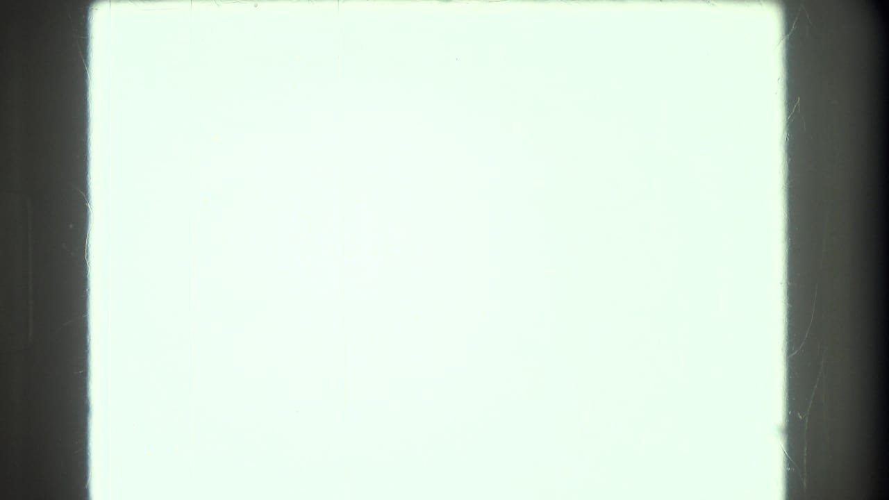 Overexposed white-green film frame with no visible image content.