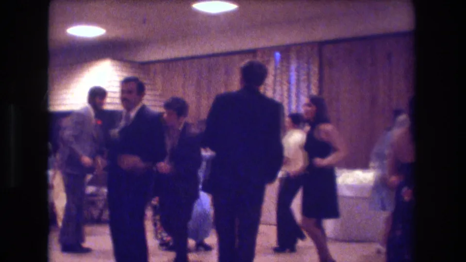 A wider view shows adults dancing and socializing in a wood-paneled Boston interior, with formal clothing and a refreshment area visible in the background.
