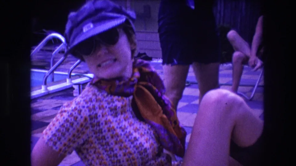 In the final 1975 Boston poolside frame, the woman reclines in the foreground wearing a cap, sunglasses, patterned dress, and scarf, with seated and standing adults nearby.