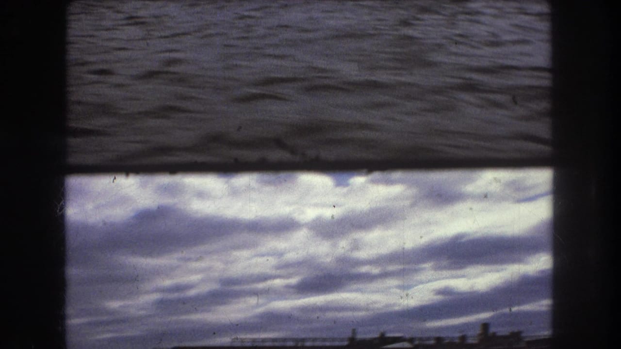 Dark rippling water fills the frame with a heavy film border.