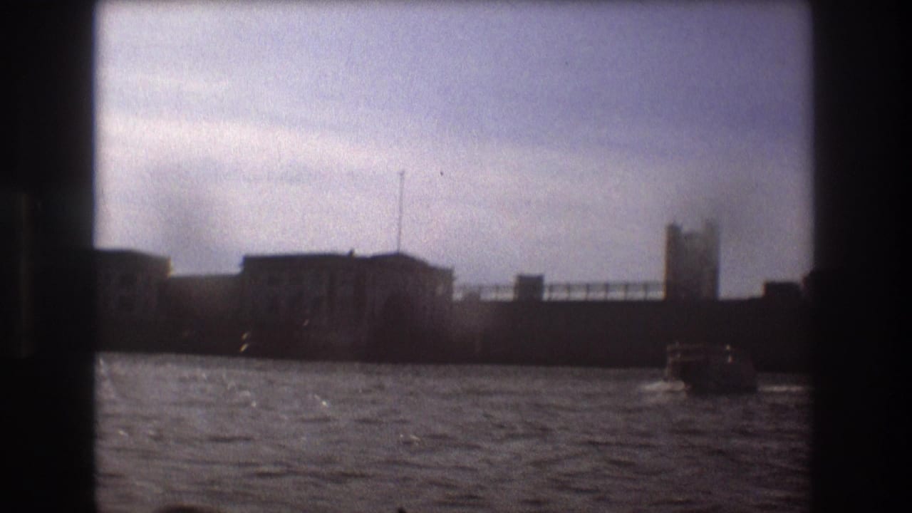 Boston waterfront structures viewed from the water in 1975 home-movie footage, with a small motorboat near the right side of the frame.