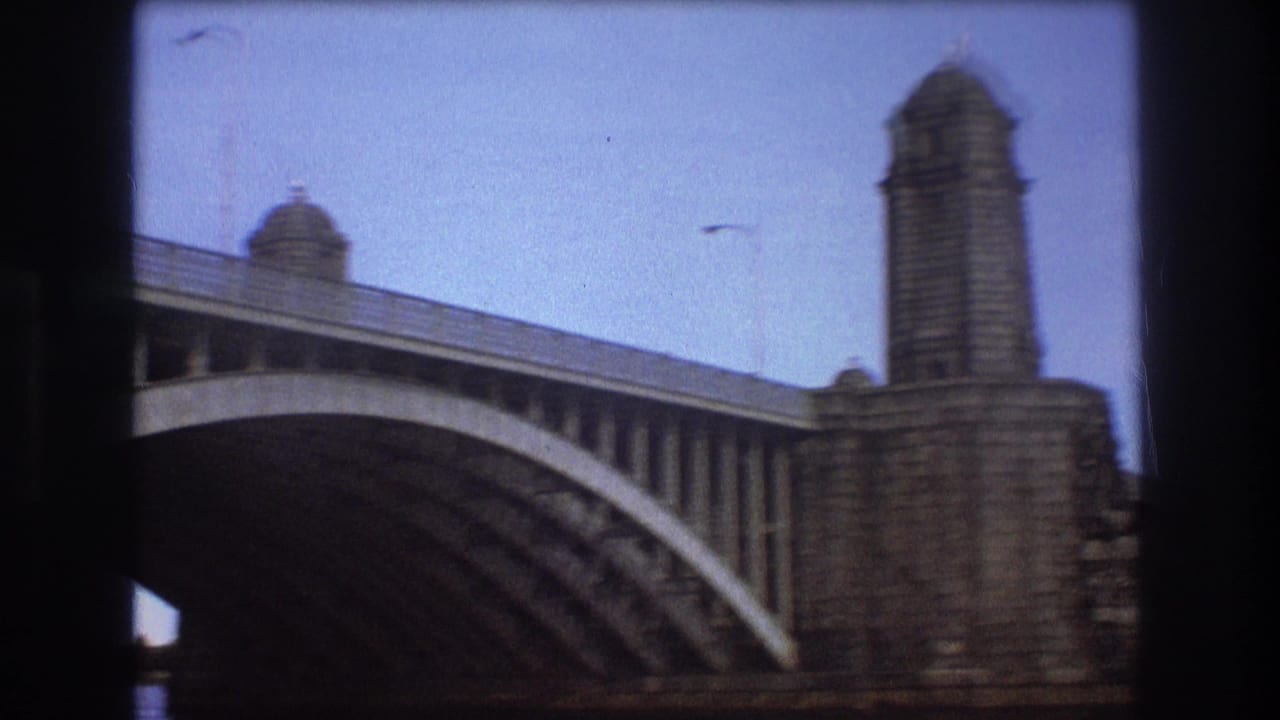 Concrete bridge with tower-like supports seen from the water.