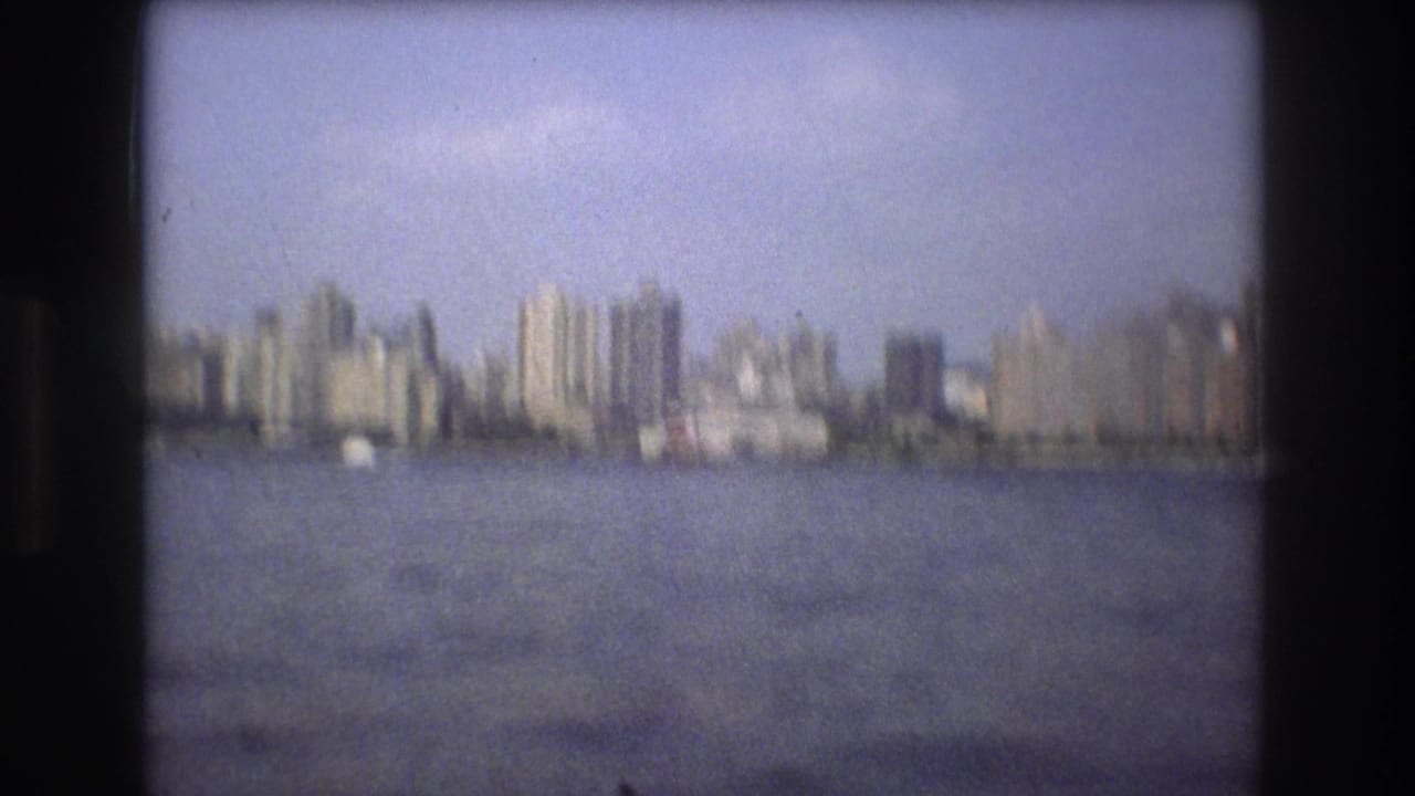 Soft-focus skyline across a wide stretch of water.