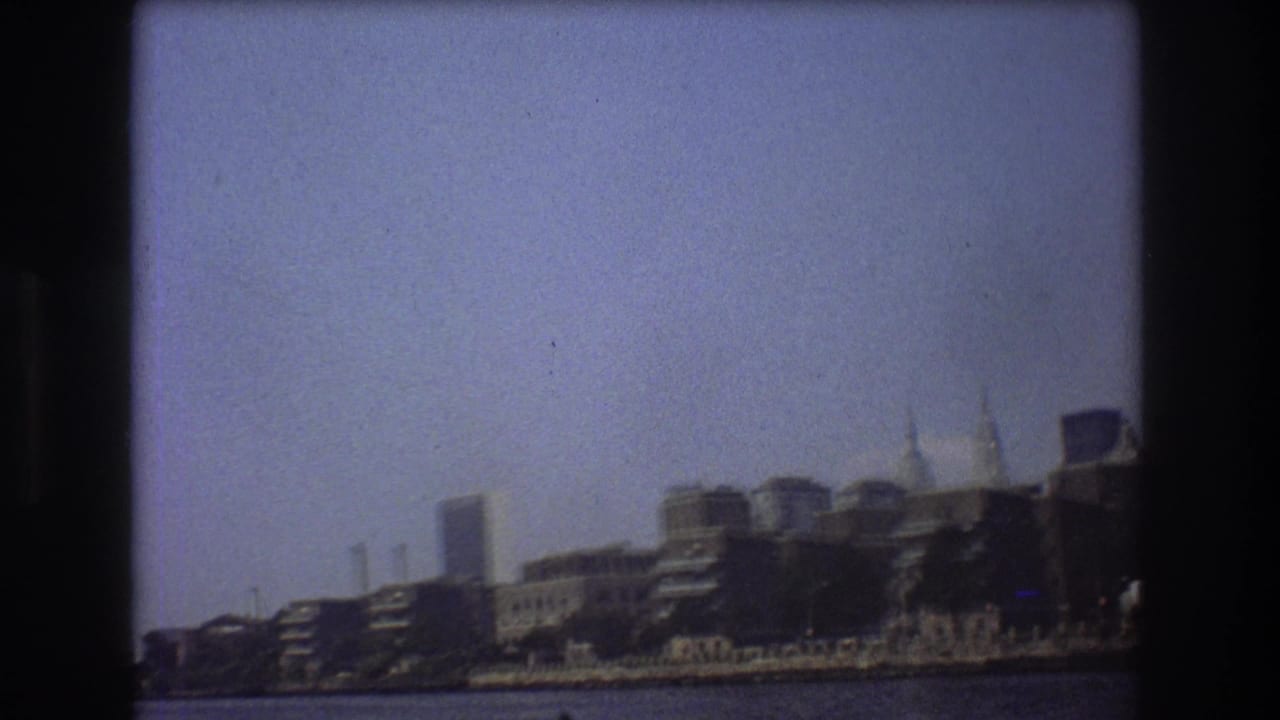 Distant city skyline across water with dark 8mm frame borders.