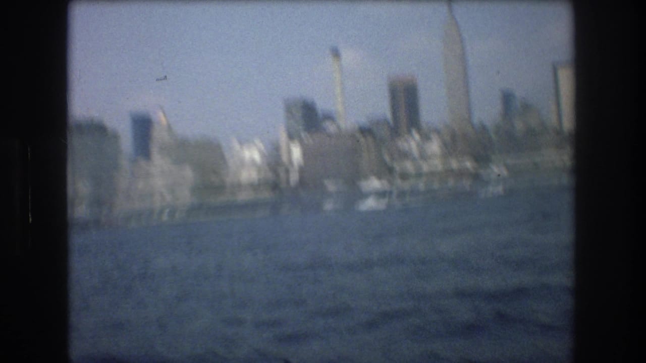 Soft distant skyline across blue harbor water with dark 8mm frame edges.