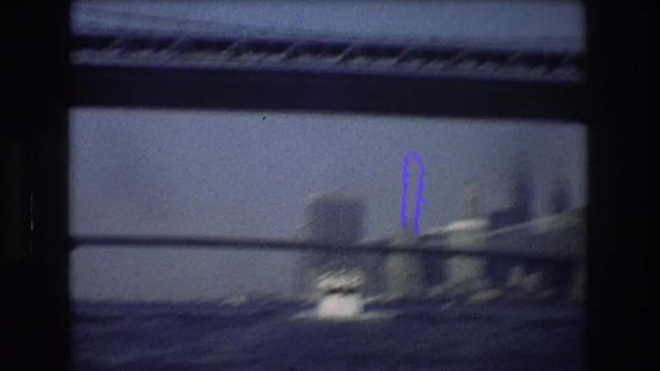 Soft 8mm frame from a New York City boat ride showing bridge supports, dark water, and a small motorboat moving through the scene.