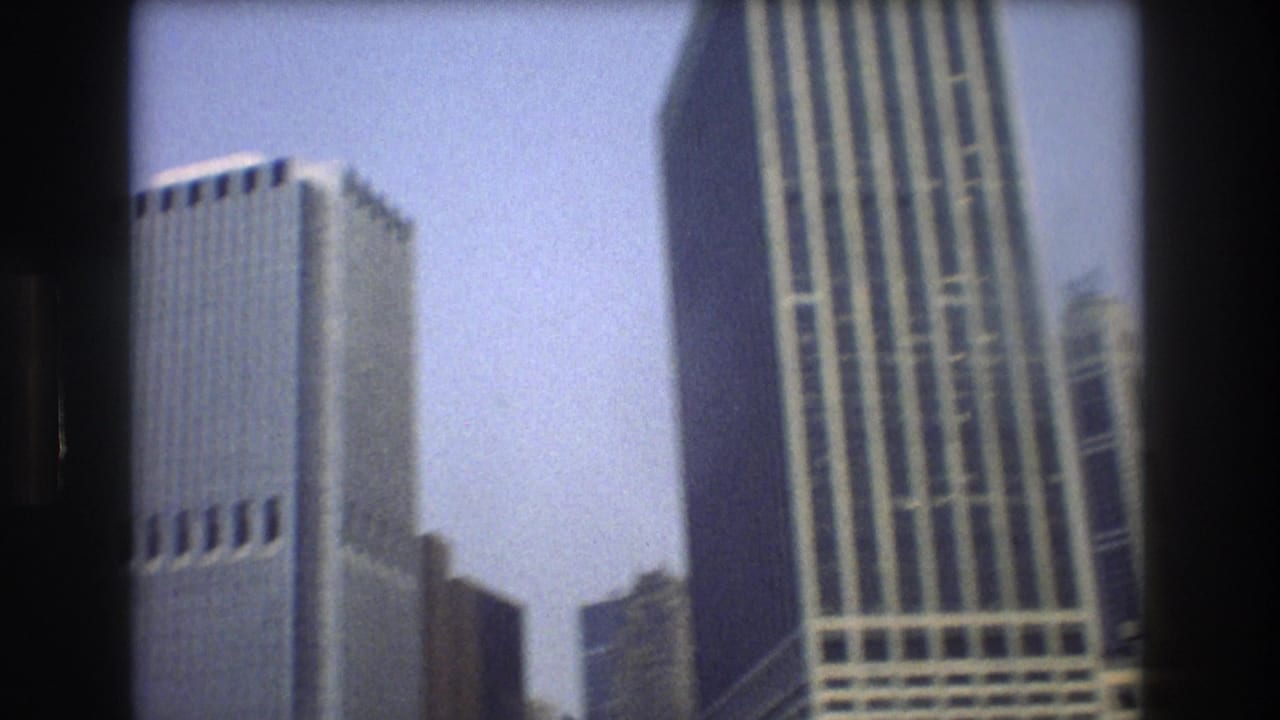 Tall Manhattan buildings seen from below against the sky.