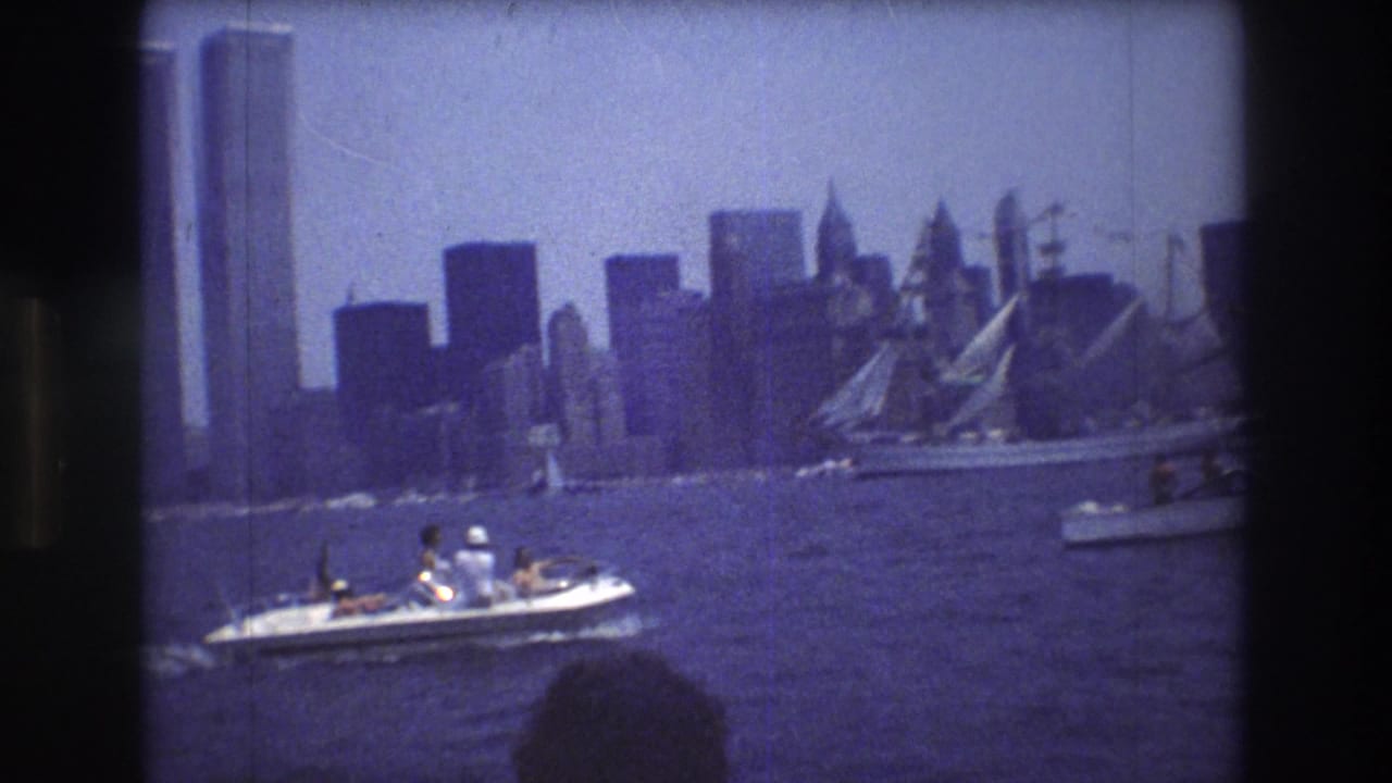 Motorboat crosses in front of the Manhattan skyline and World Trade Center towers.