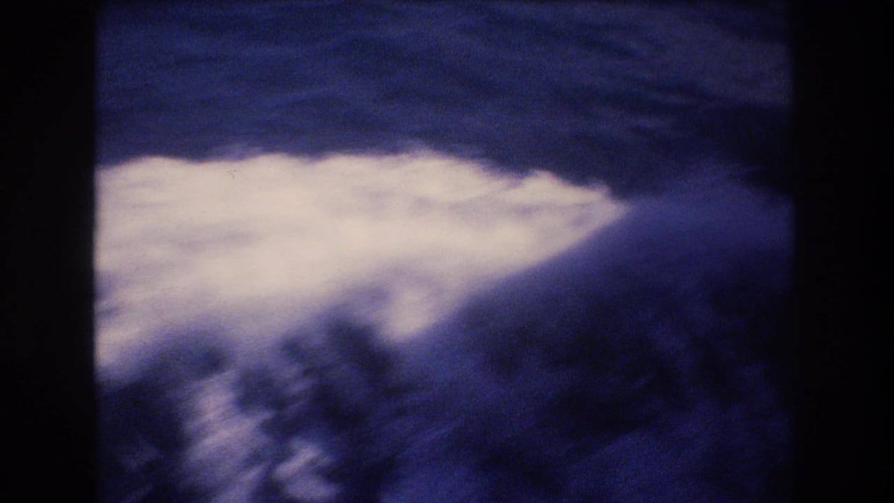 White foamy boat wake cutting across dark blue water.