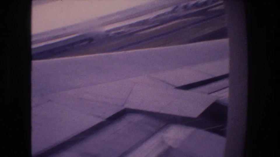 Final frame shows the aircraft wing and flap surfaces through the passenger window as the plane appears to continue its cloudy approach toward Honolulu.