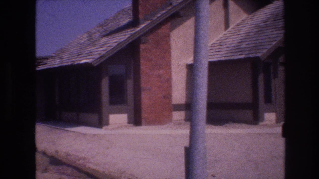 Two adjacent house exteriors seen from a quiet street with shingle roofs and brick accents.