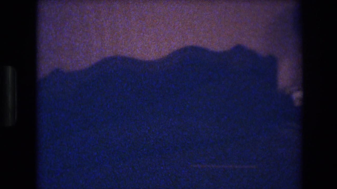 Silhouetted decorative furniture top — possibly a headboard or cabinet — in a 1977 Las Vegas interior shot on 8mm film.