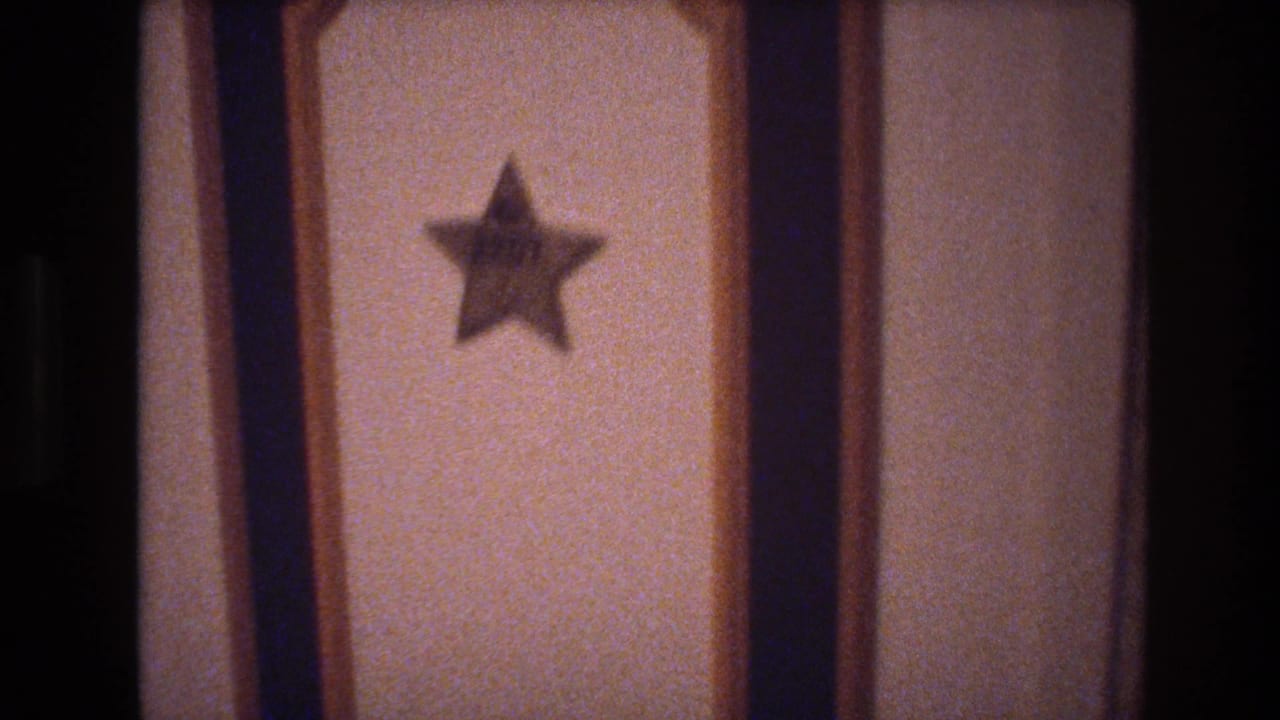 8mm close-up of a hotel room door with a five-pointed star emblem on a cream panel, c. 1977 Las Vegas.
