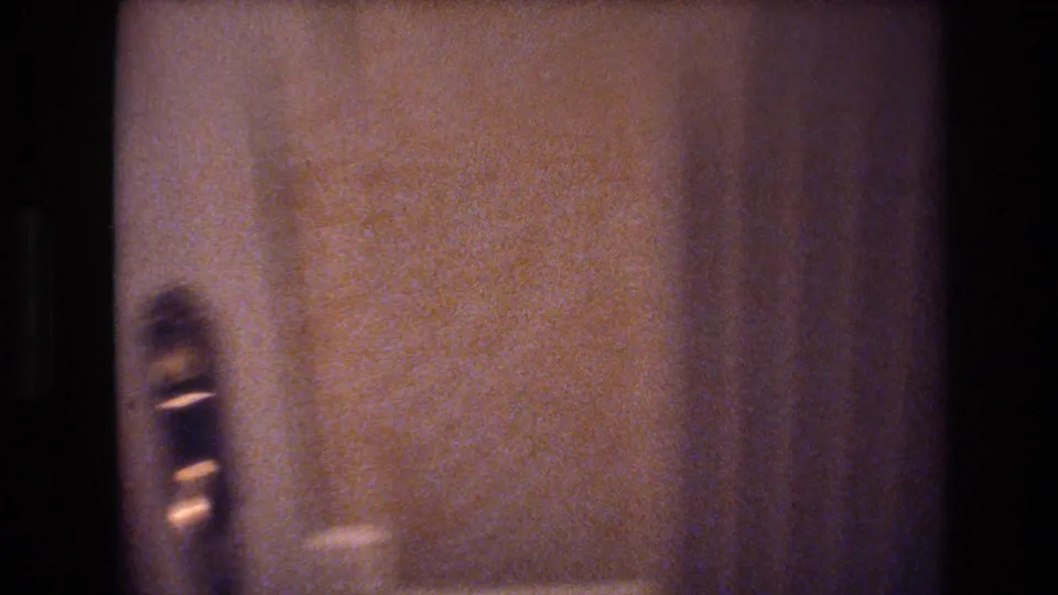 8mm close-up of a brass door handle and textured tan wallcovering in a hotel corridor, c. 1977 Las Vegas.