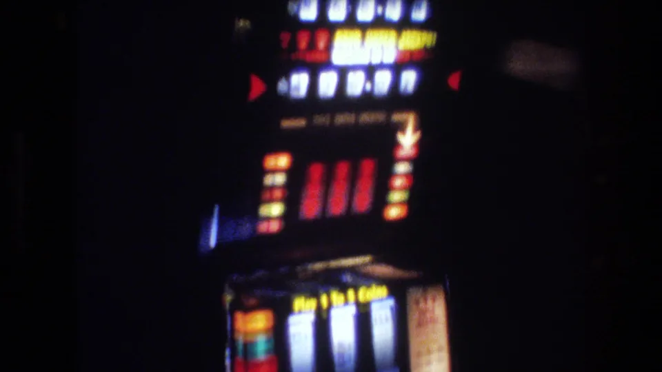 Las Vegas slot machine circa 1977 showing full display panel with 'Play 1 to 5 Coins' instruction, red side-arrow indicators, 7s pay line, and multi-row jackpot pay table.