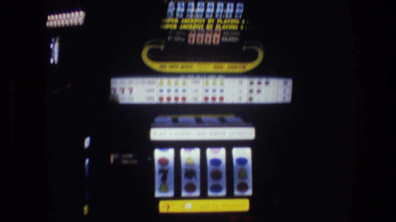 Slot machine with "RED ARROW" branding, illuminated payout display board, and reels showing a seven symbol and circular symbols, against a dark background.