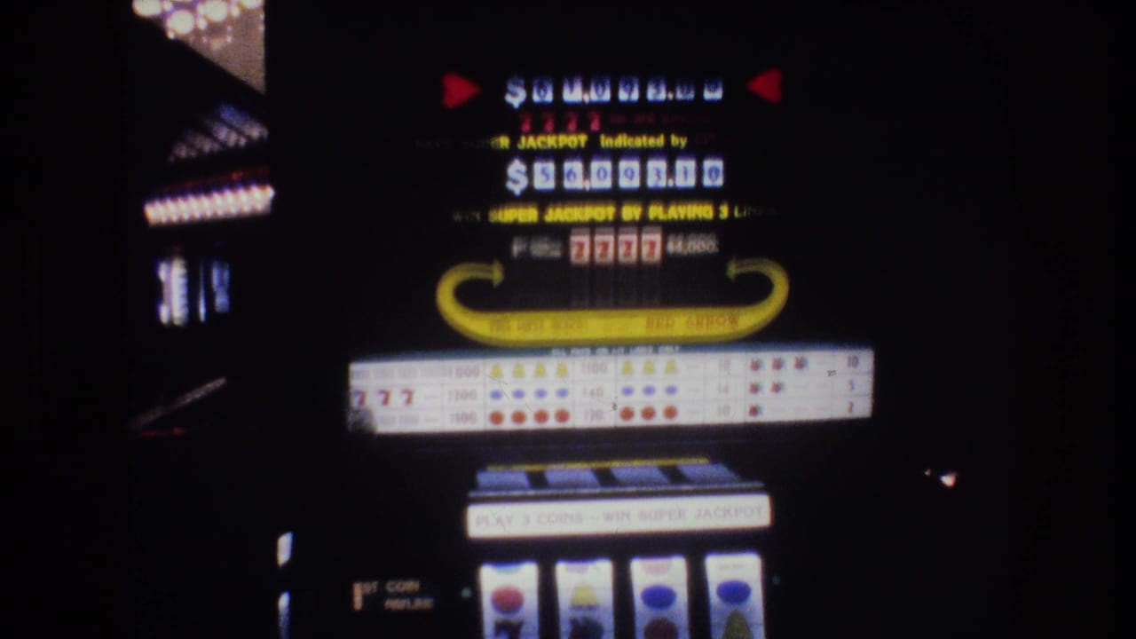 Slot machine illuminated display showing Super Jackpot amount and 7777 combination in a dark casino environment.